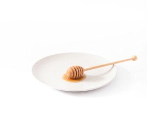honey-dipped spoon resting on a plate