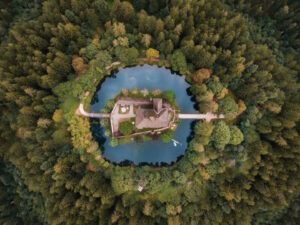 Bird's eye view of a Moat surrounding a castle in a forest